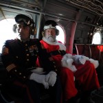 Santa Claus & Sgt. Iversen deliver Christmas gifts to children